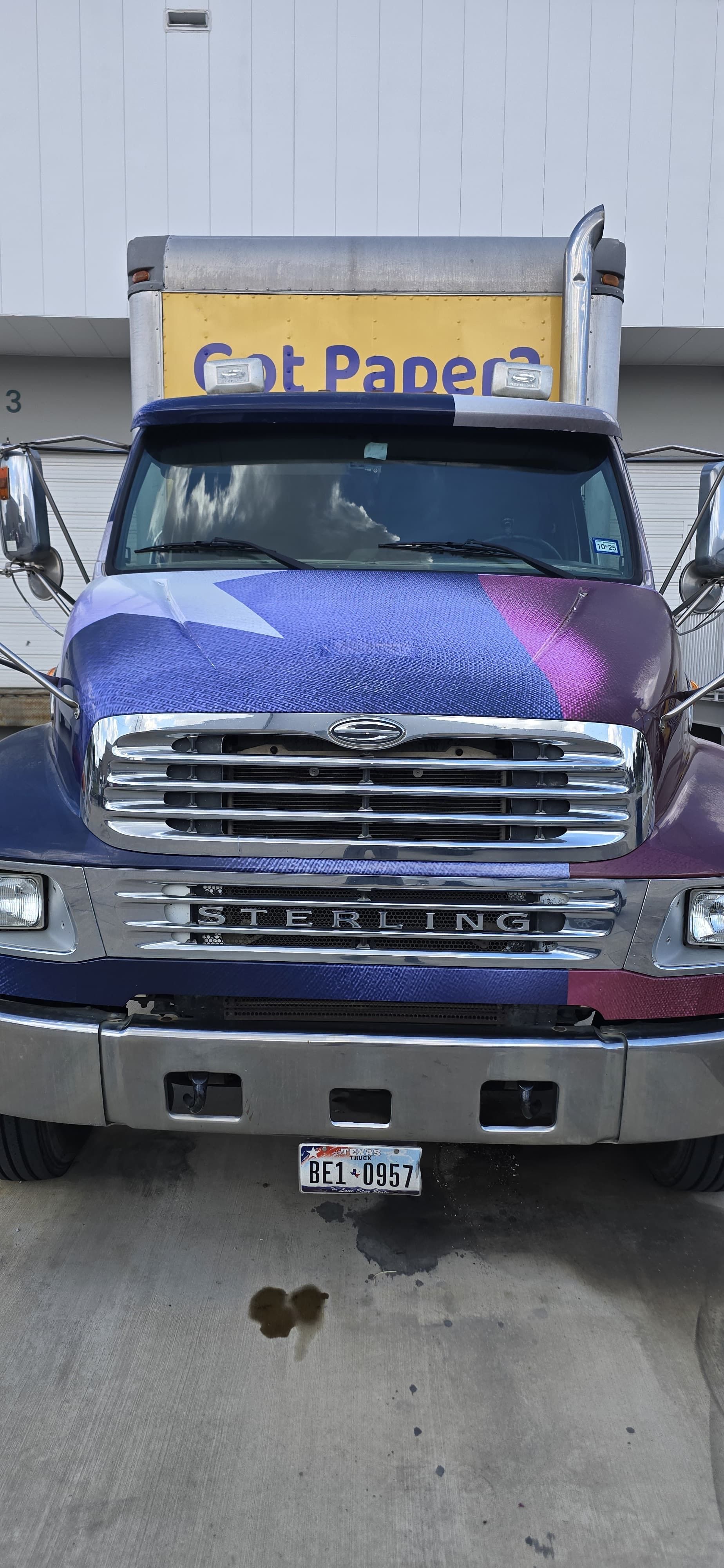 Front of a truck with a colorful design and 
