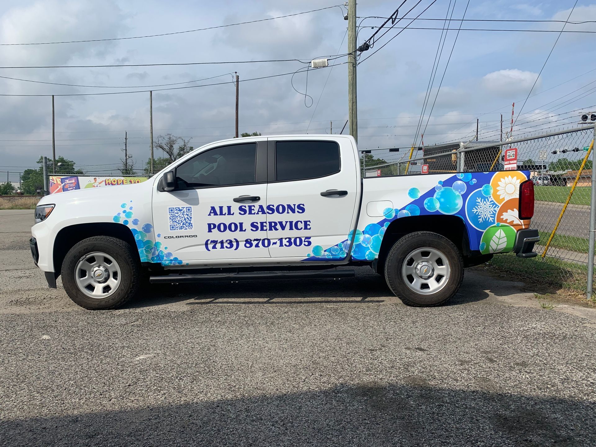 White pickup truck with blue and green pool service graphics; All Seasons Pool Service.