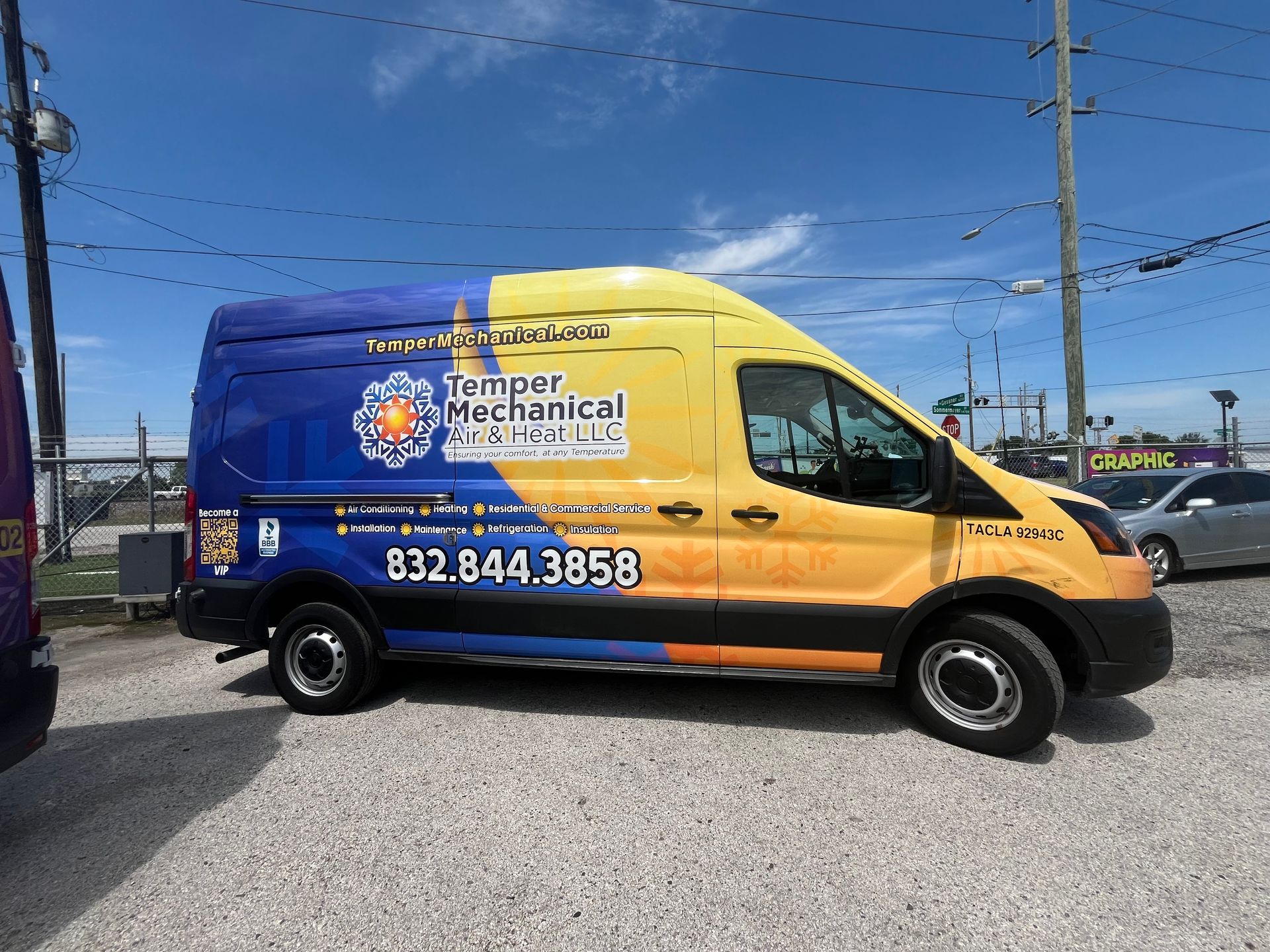 Blue and yellow Temper Mechanical Services van parked outdoors with phone number visible.