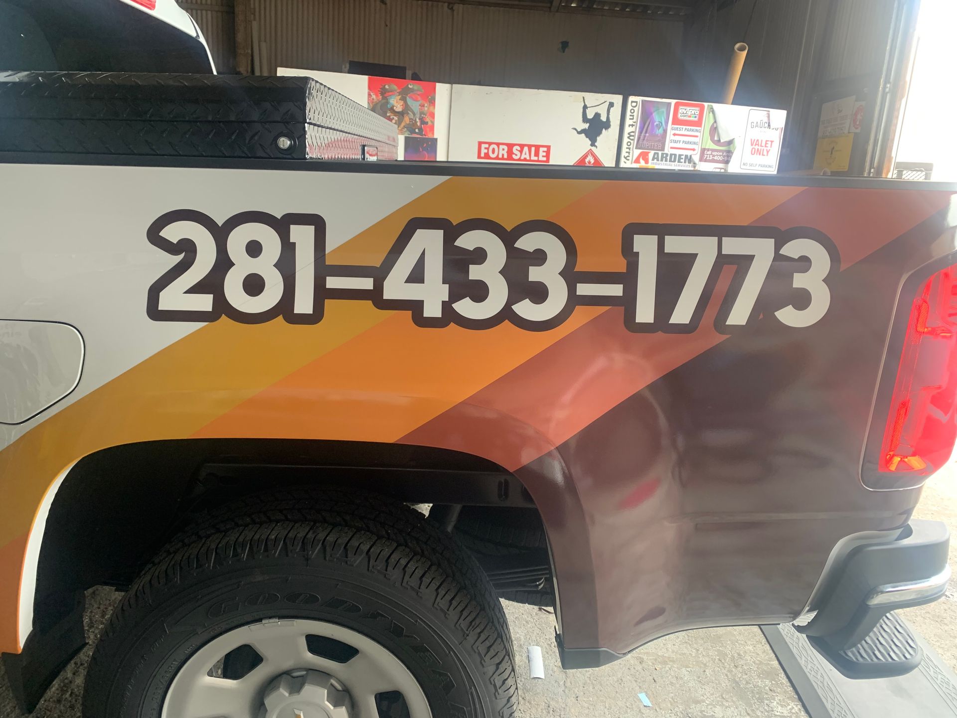 Truck with phone number 281-433-1773 on the side; white, orange, and brown color scheme.