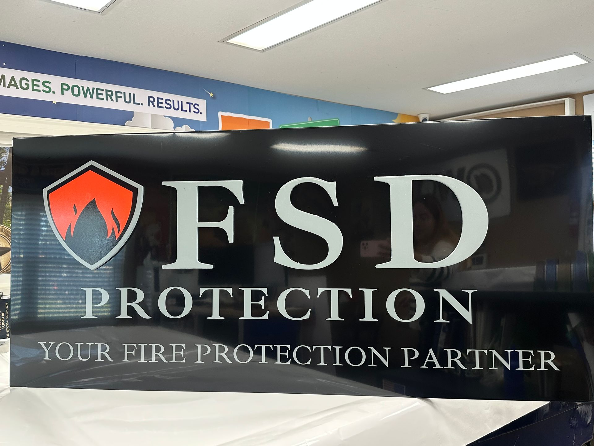 Black sign with silver lettering: 