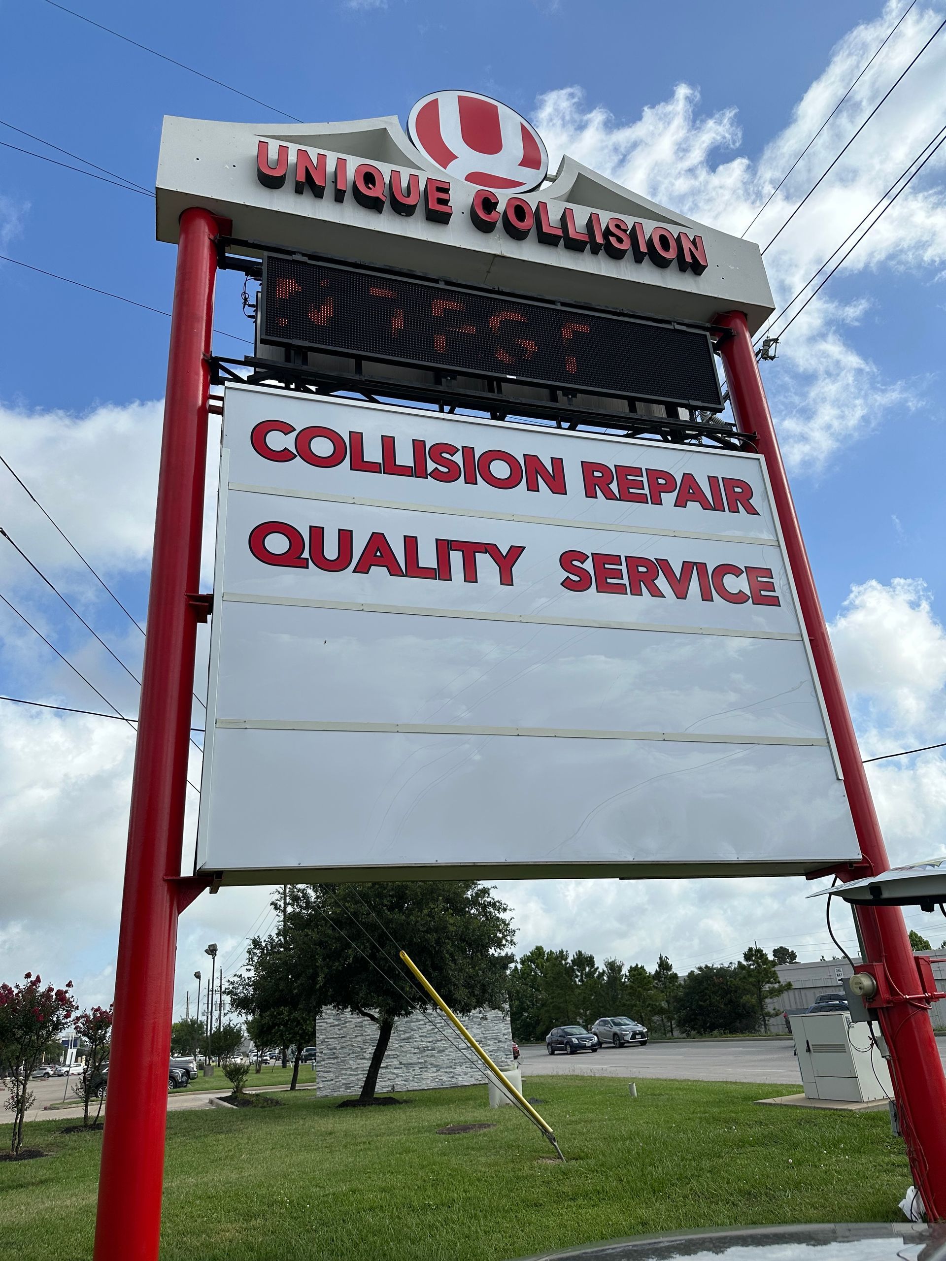 Sign for Unique Collision, red frame, white background, displaying 