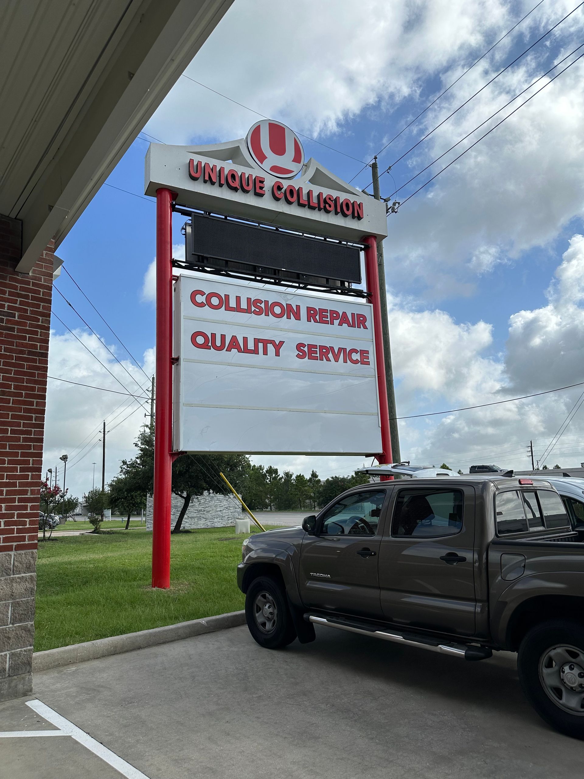Sign for Uncle Collision, featuring a truck, lists 
