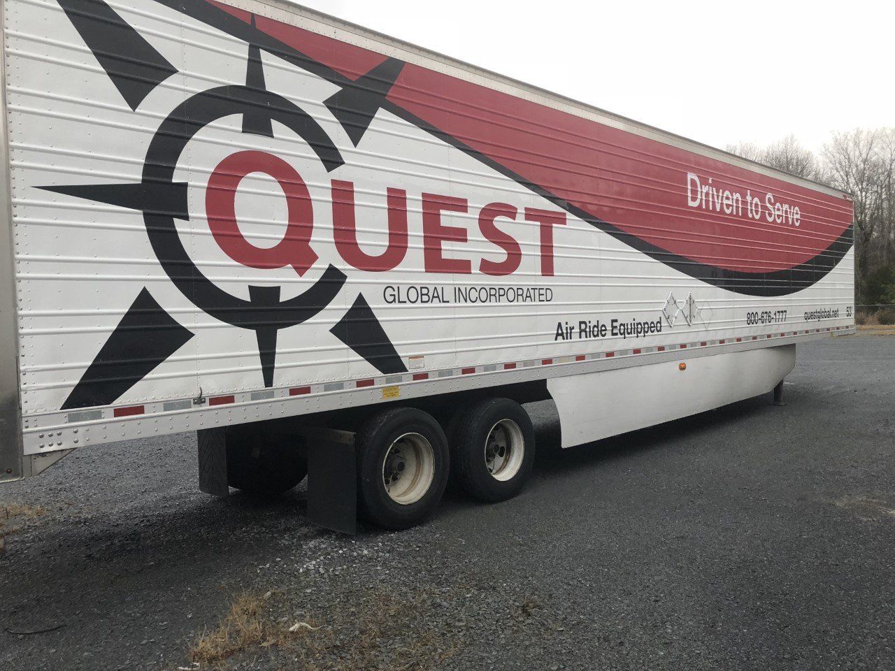 A quest trailer is parked on the side of the road