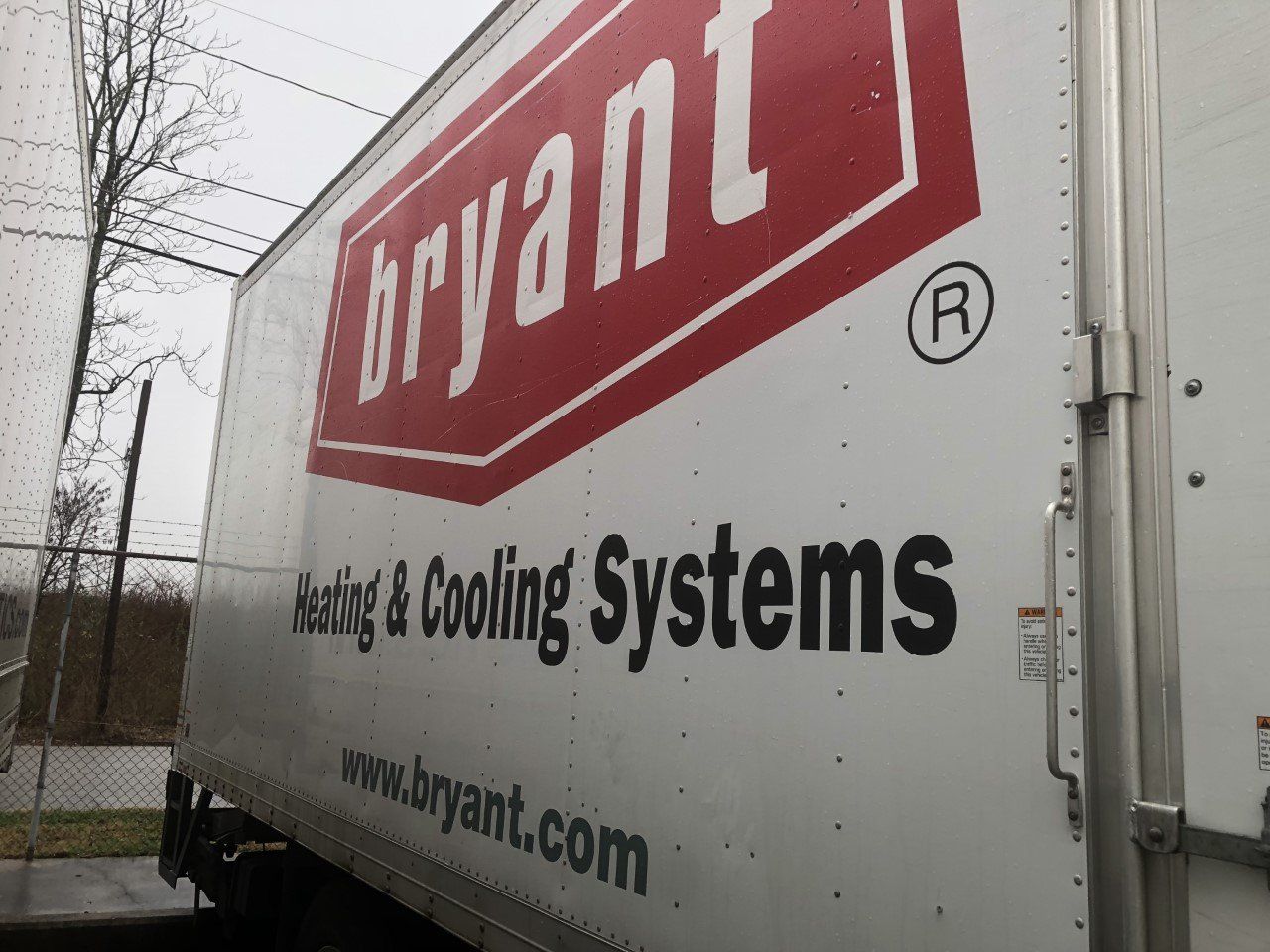 A white and red bryant heating and cooling systems truck