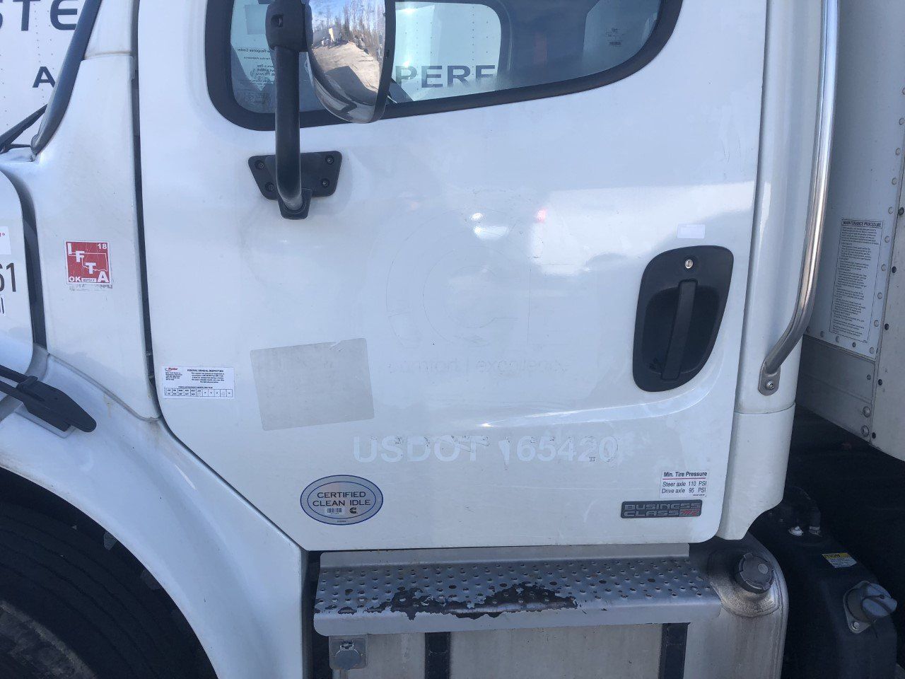 A white truck with the word here on the door