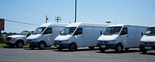 a fleet of white vans