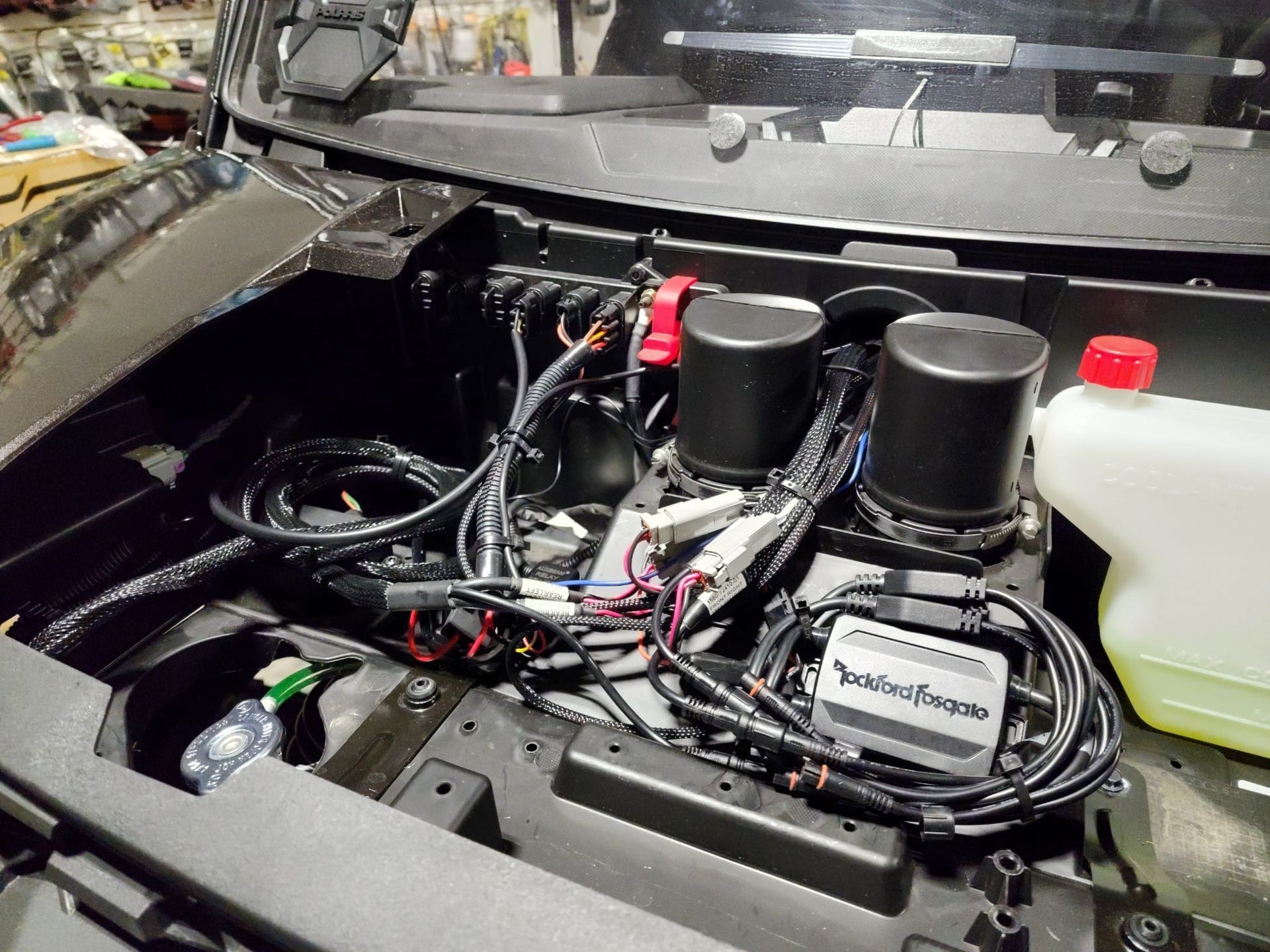 The hood of a car with a lot of wires coming out of it