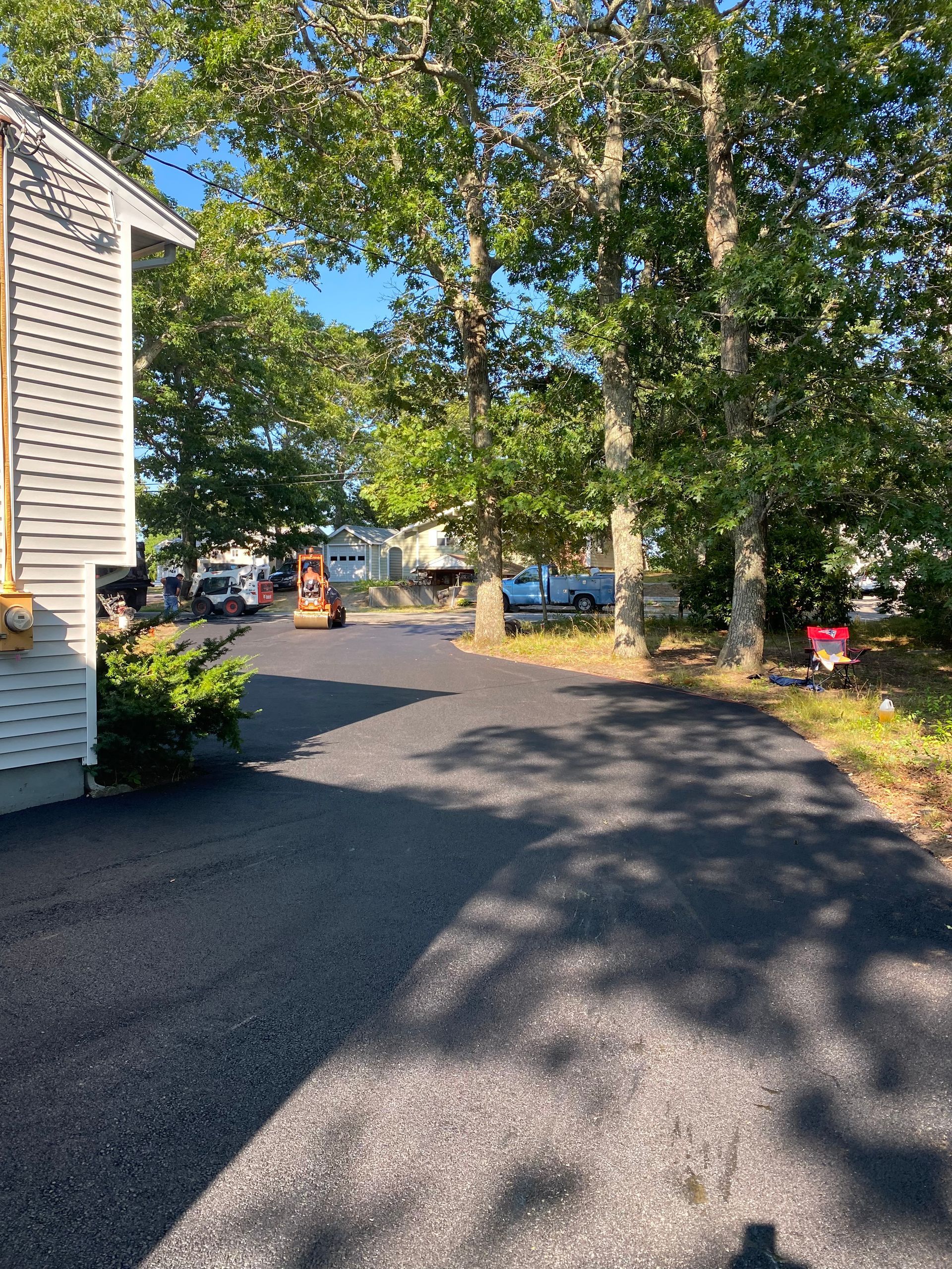 asphalt paving equipment on a driveway