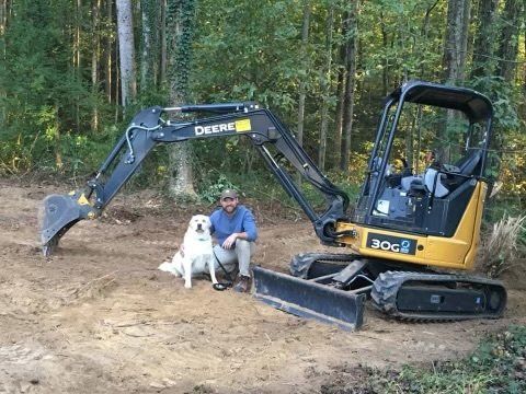 Bradley with his dog and excavator