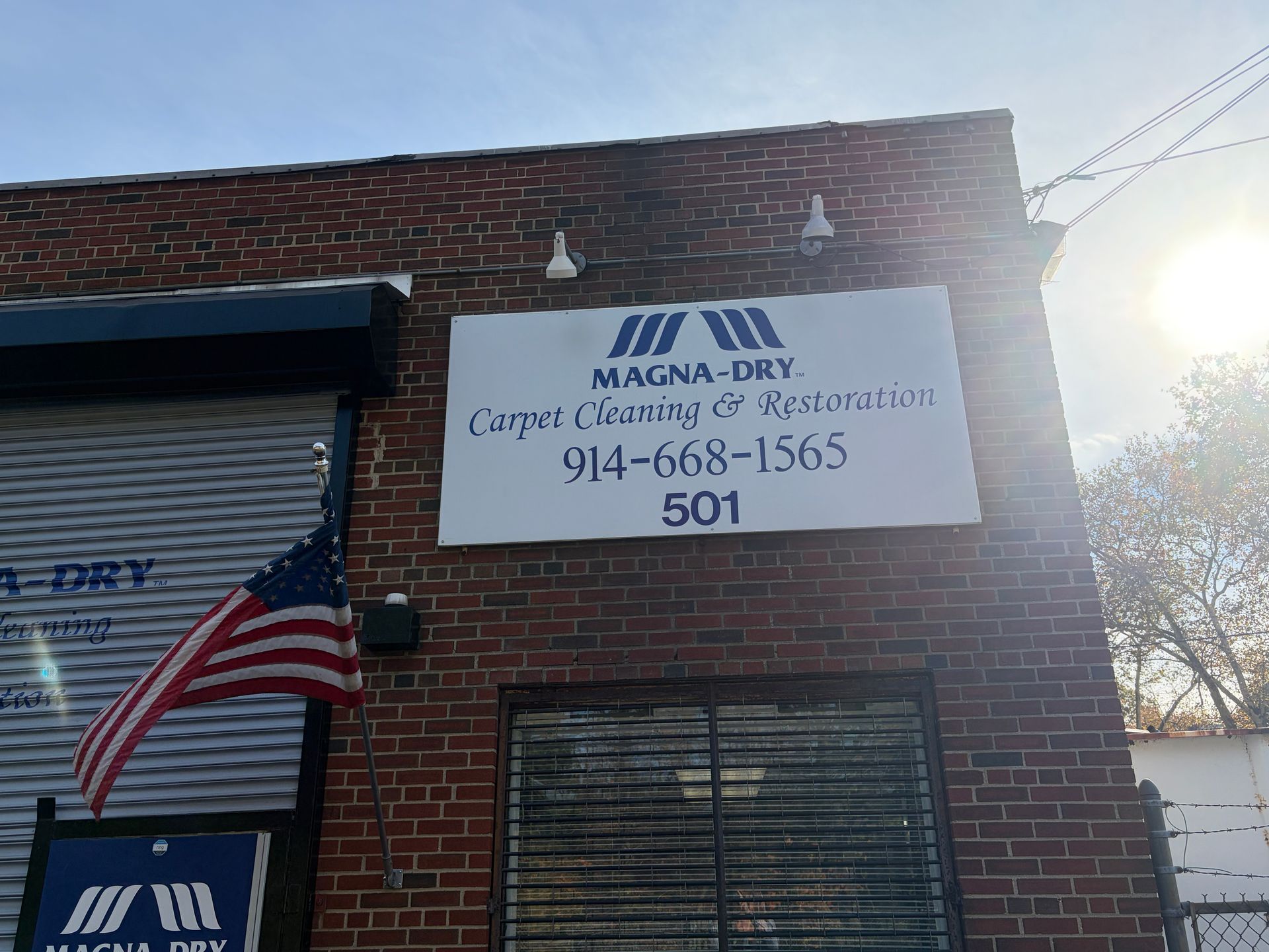 Magna-Dry building with sign, American flag, and phone number 914-668-1565.