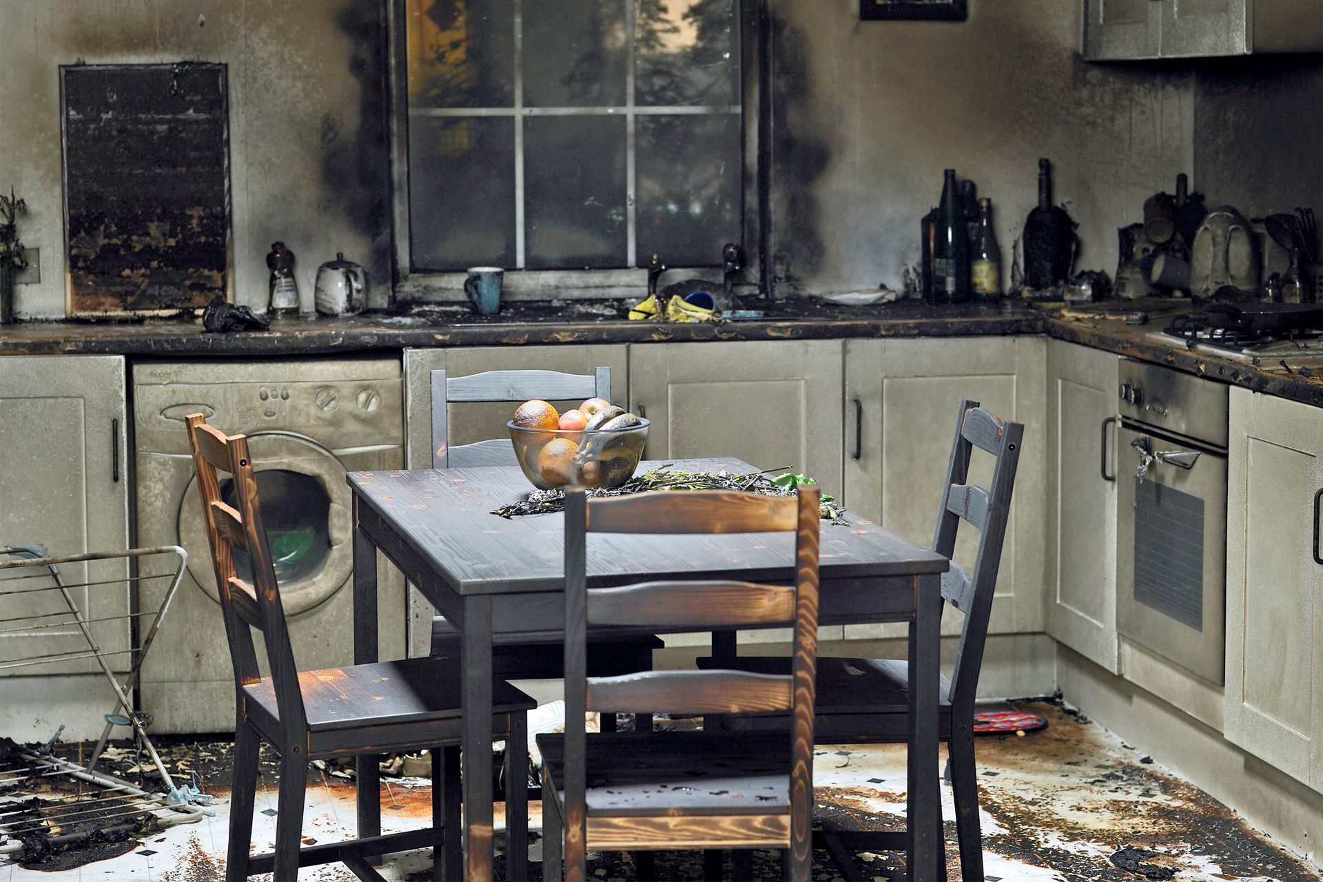 Moldy wooden planks and beams in an attic space. The wood is brown with patches of blue and green mold.
