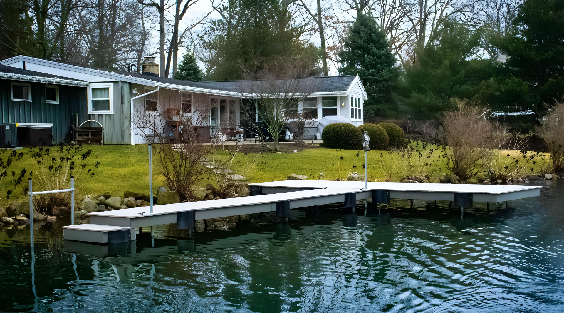 A house is sitting next to a body of water.