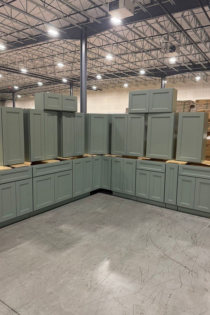 Stacks of green storage crates arranged in rows inside a warehouse.