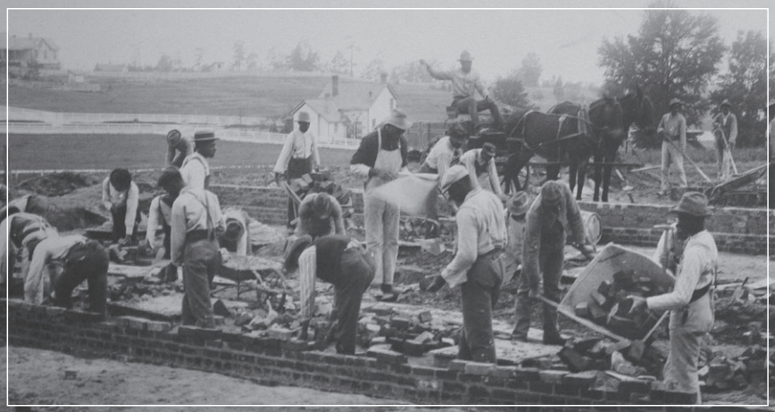 People working and carrying bricks.