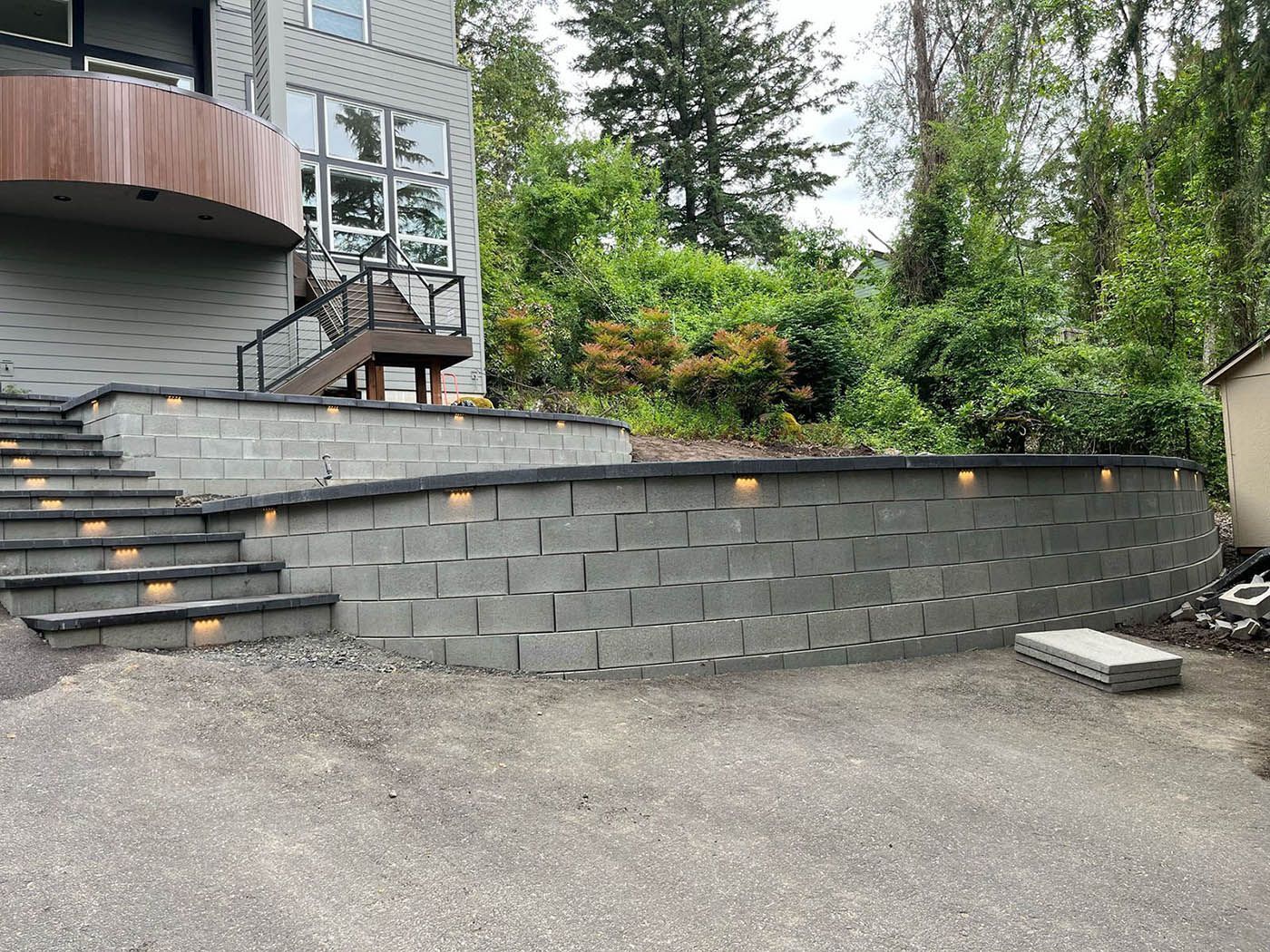 A brick wall with stairs leading up to a house