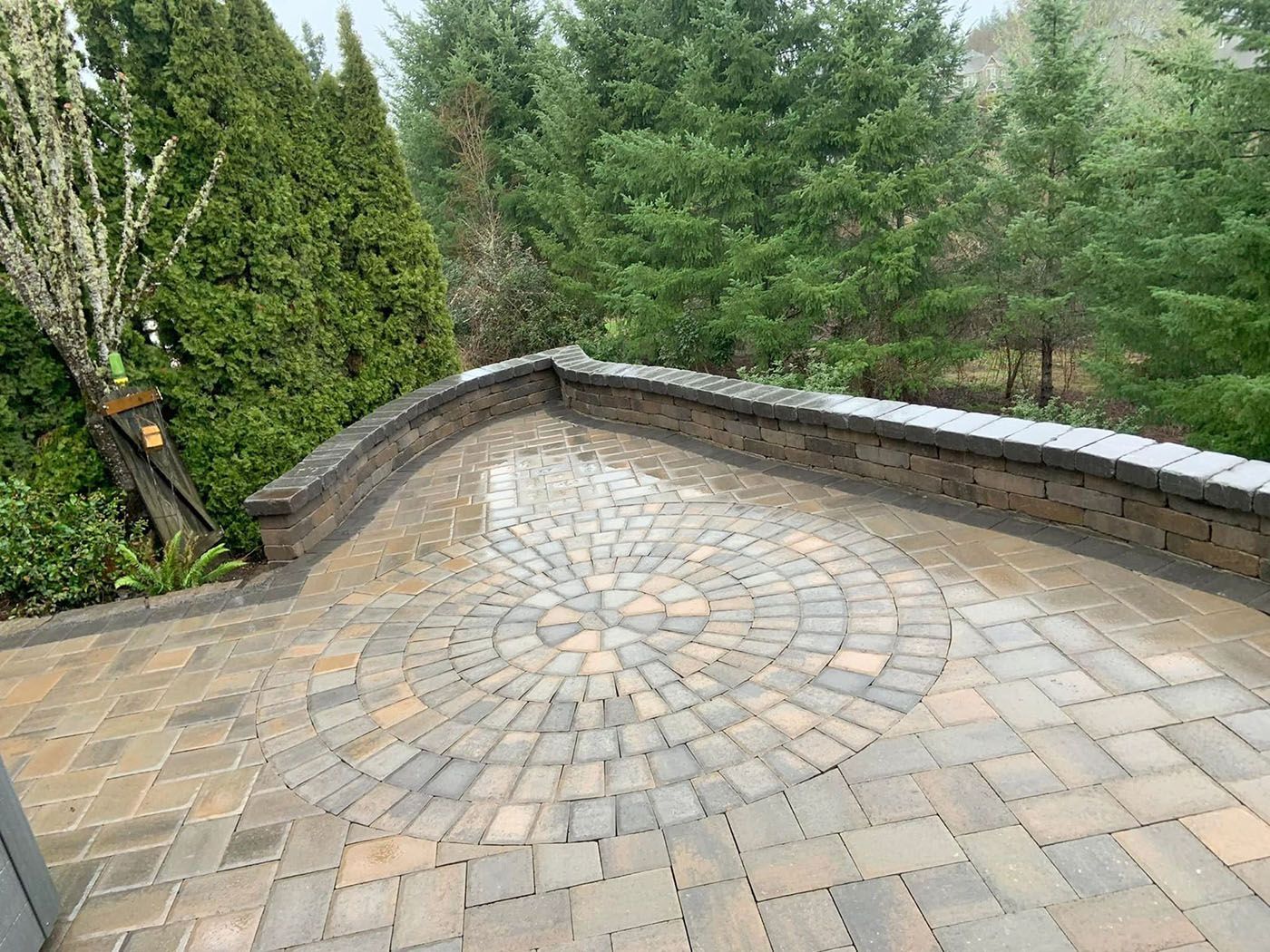 A brick patio with a circular design