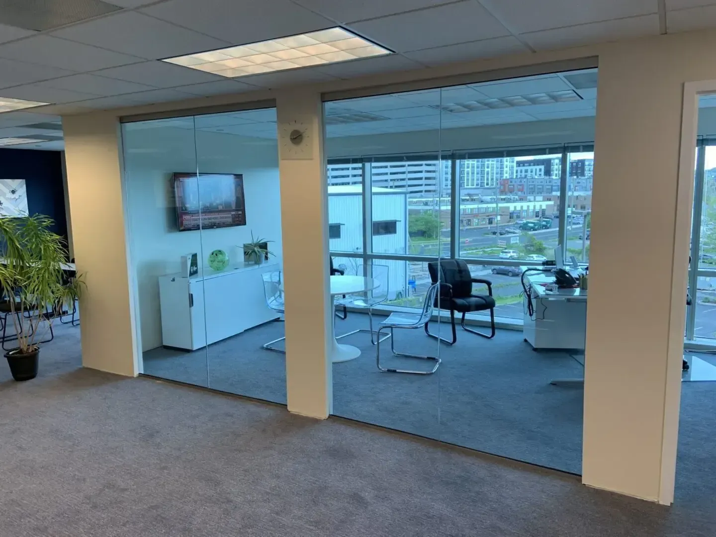 A room with a lot of windows and a tv on the wall.