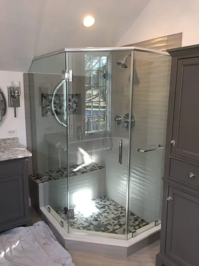 A bathroom with a walk in shower and a sink.
