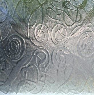 A close up of a glass door with a pattern on it.