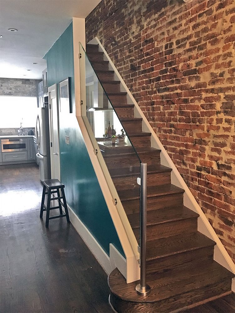 A room with a glass railing and a lot of windows