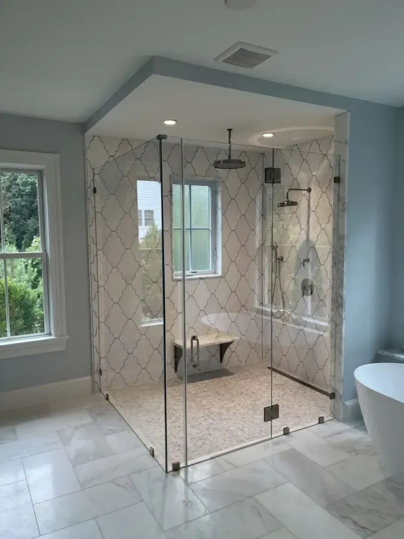 A bathroom with a walk in shower , tub , and window.