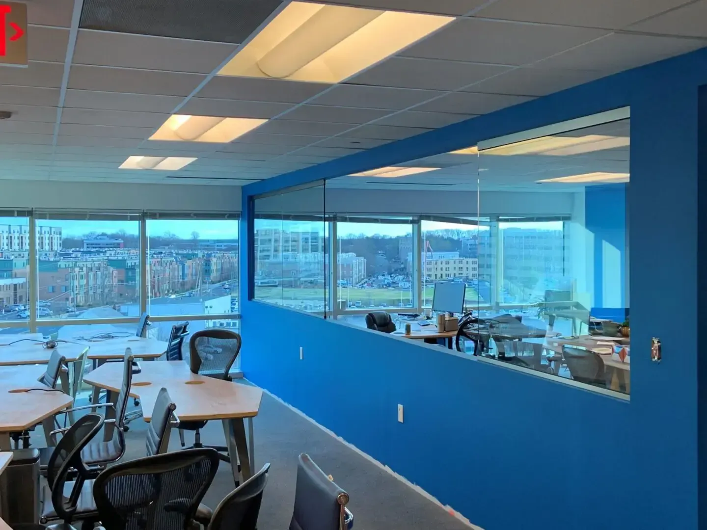 A large room with blue walls and tables and chairs