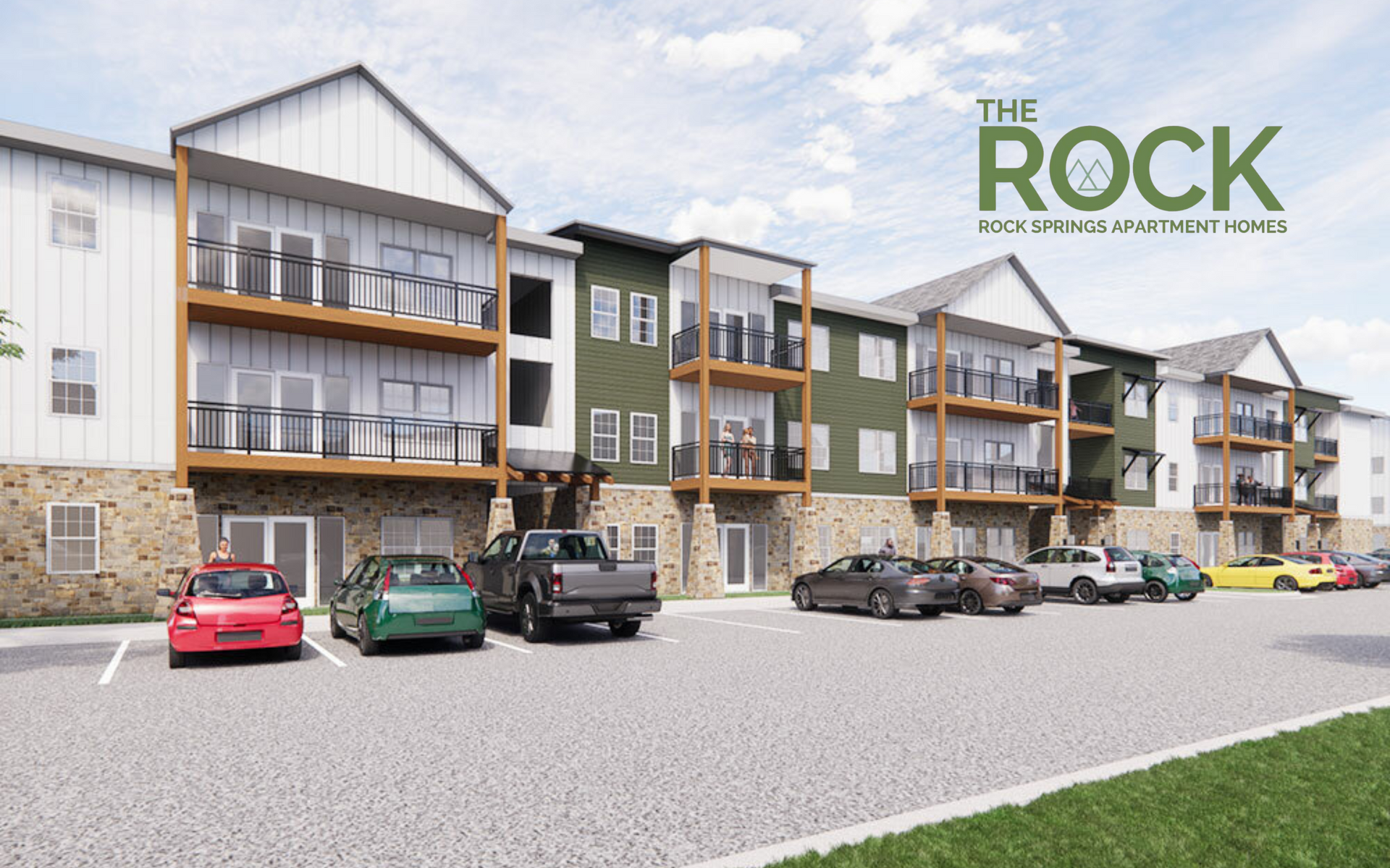 The Rock apartment complex with parked cars in front.