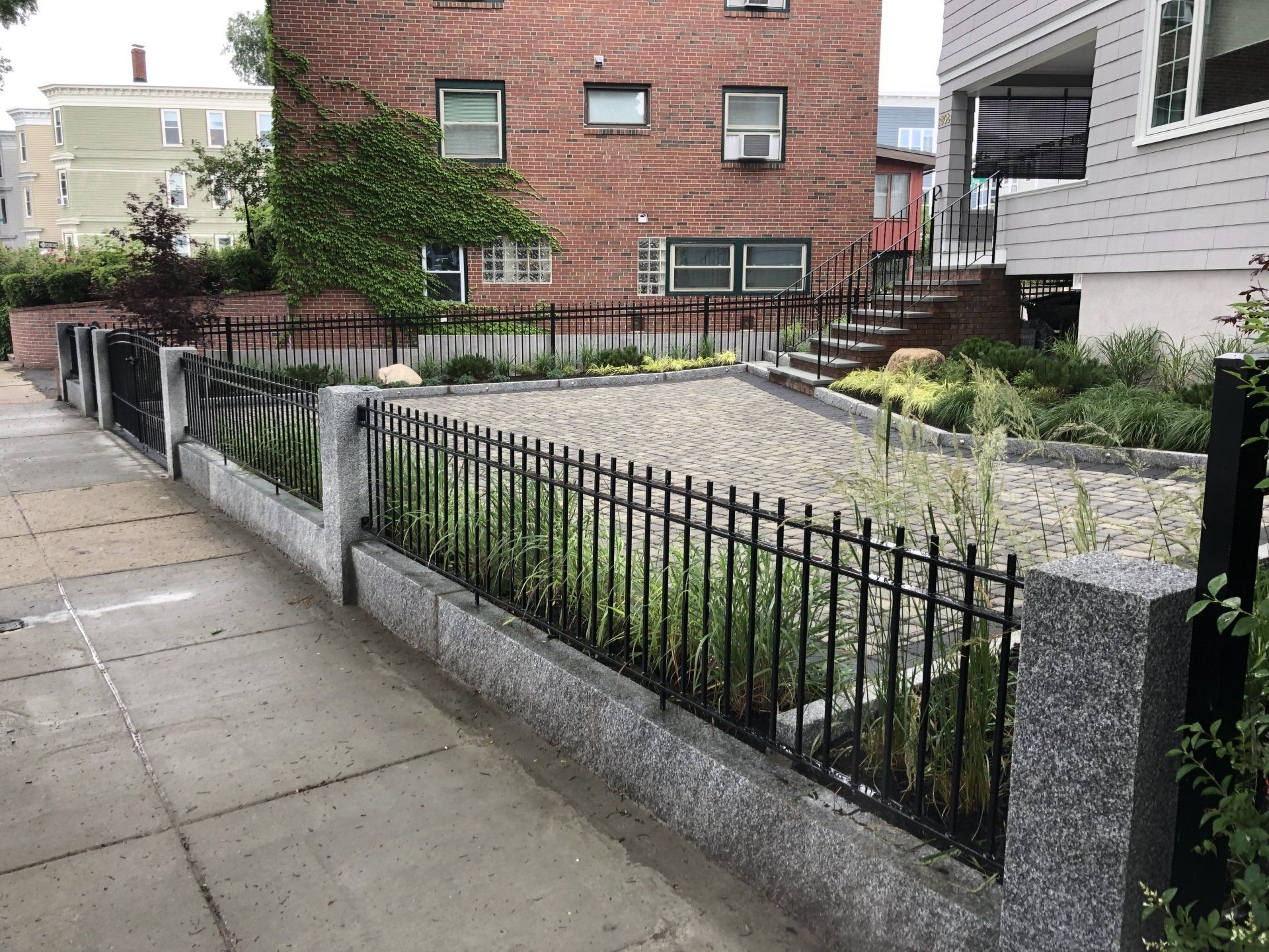 A brick building with a fence in front of it