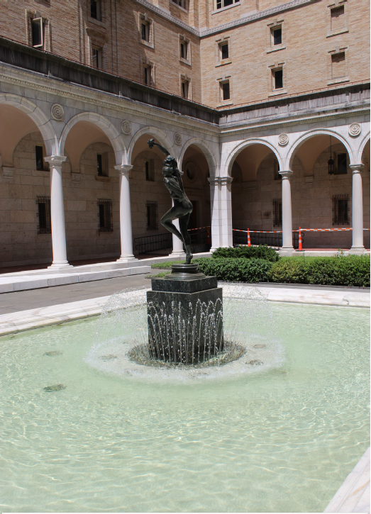 A fountain with a statue in the middle of it