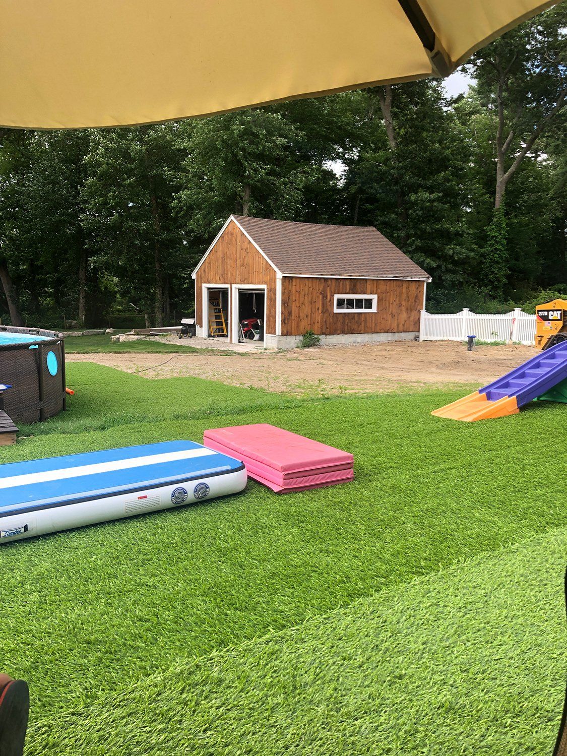 There is a house in the background and a playground in the foreground.