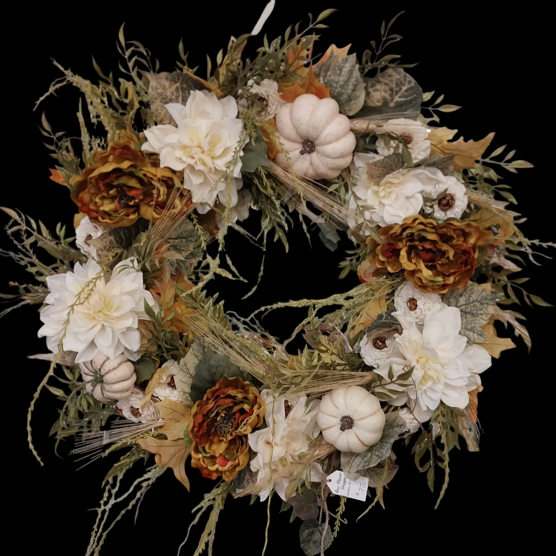 Fall wreath with white pumpkins, brown and white flowers, and foliage.