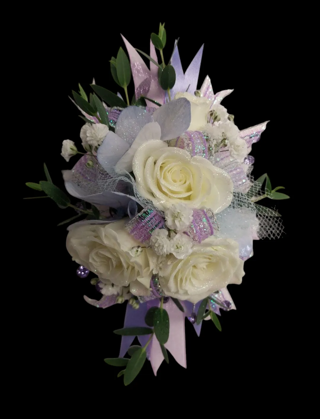 White rose corsage with accents of lavender ribbon and greenery.
