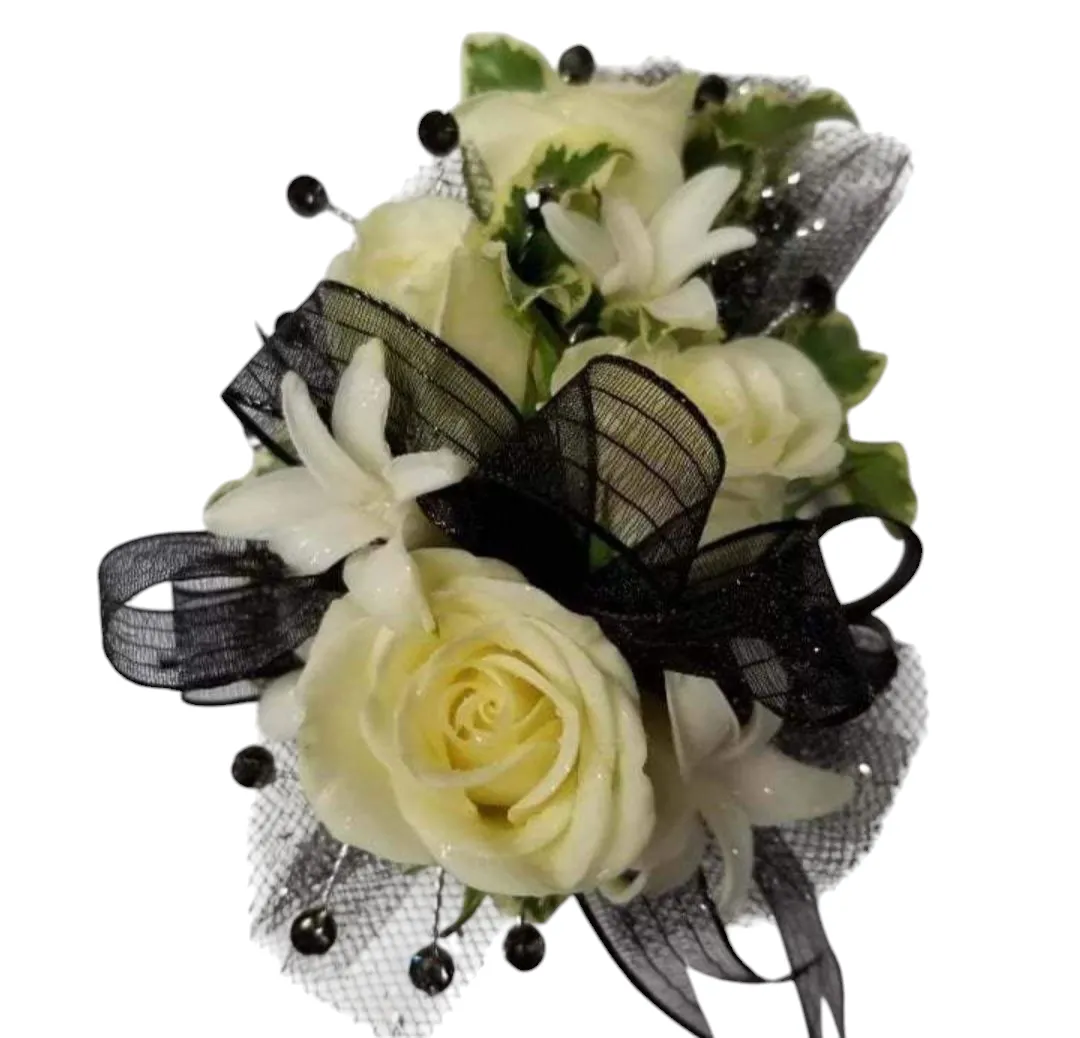 White rose corsage with black ribbon and accents.