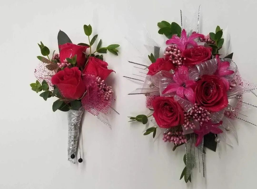 Two pink floral arrangements: a boutonniere and a wrist corsage, on a white background.