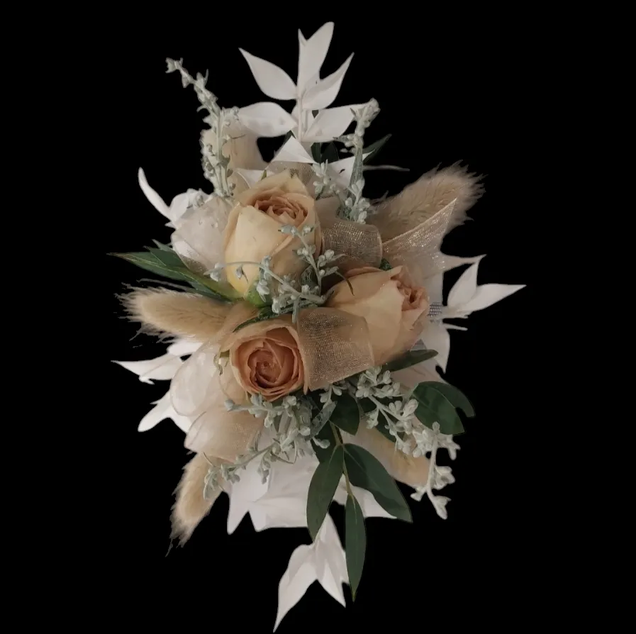 Dried flower arrangement with tan roses, pampas grass, and white foliage.