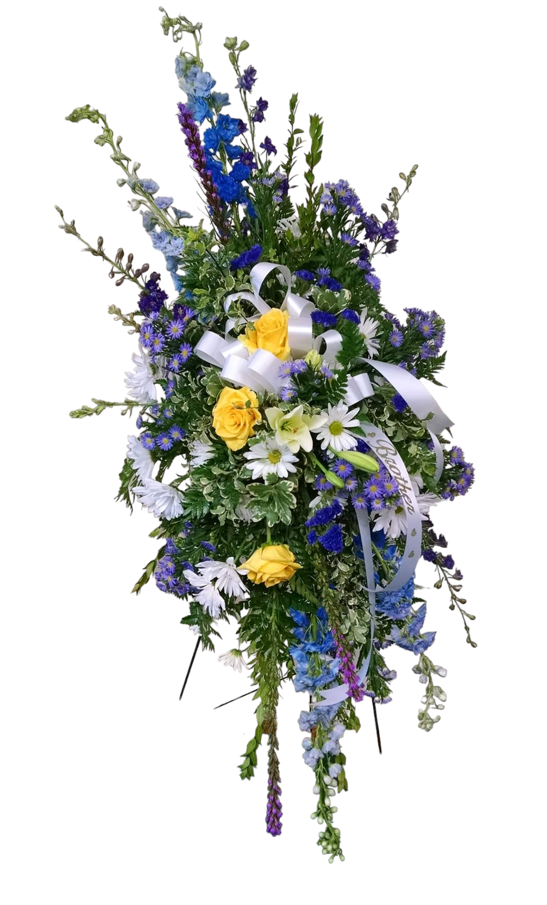 Funeral flower spray with blue, purple, yellow, and white flowers, accented with white ribbon.