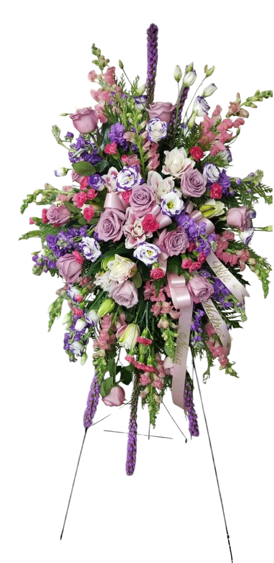 Floral arrangement in purple, pink, and white on a stand.