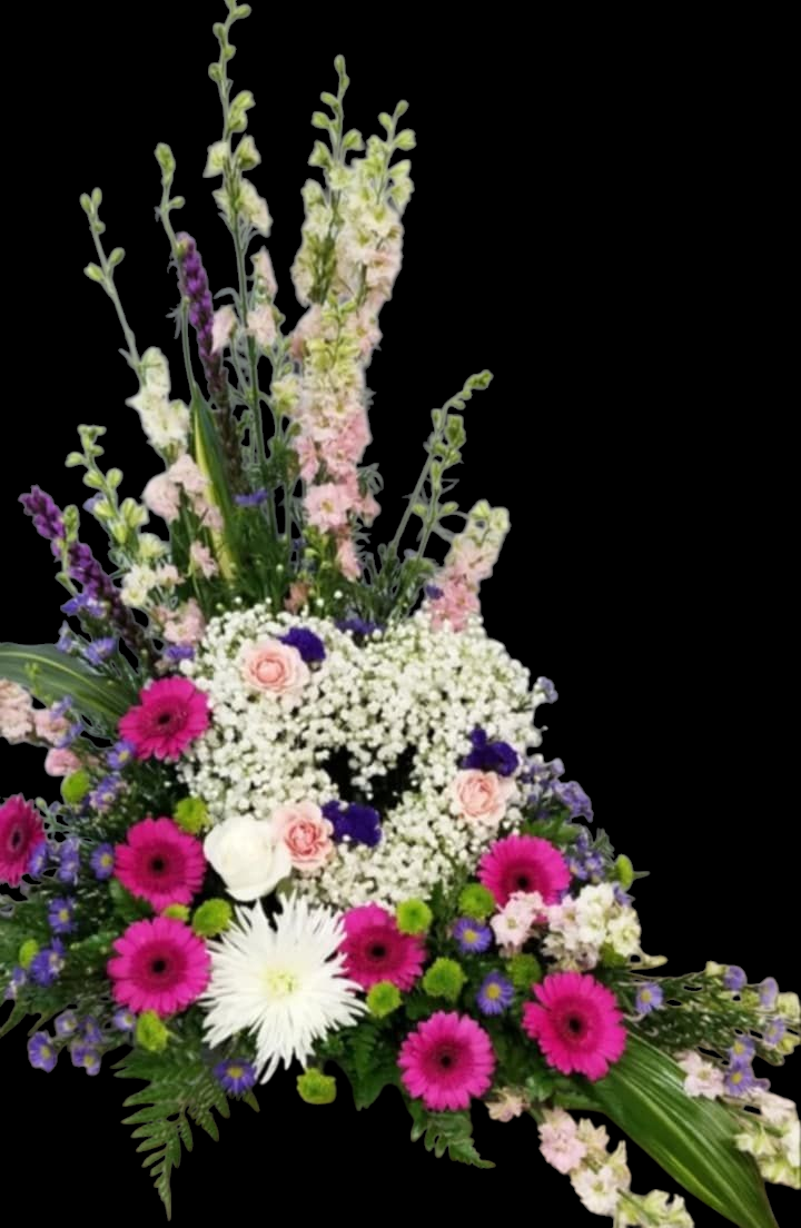 Floral arrangement with pink, white, and purple flowers, forming a heart shape on a black background.