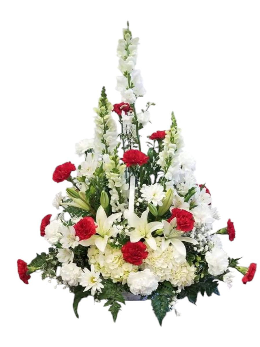 Floral arrangement with white lilies, snapdragons, and carnations, and red carnations.