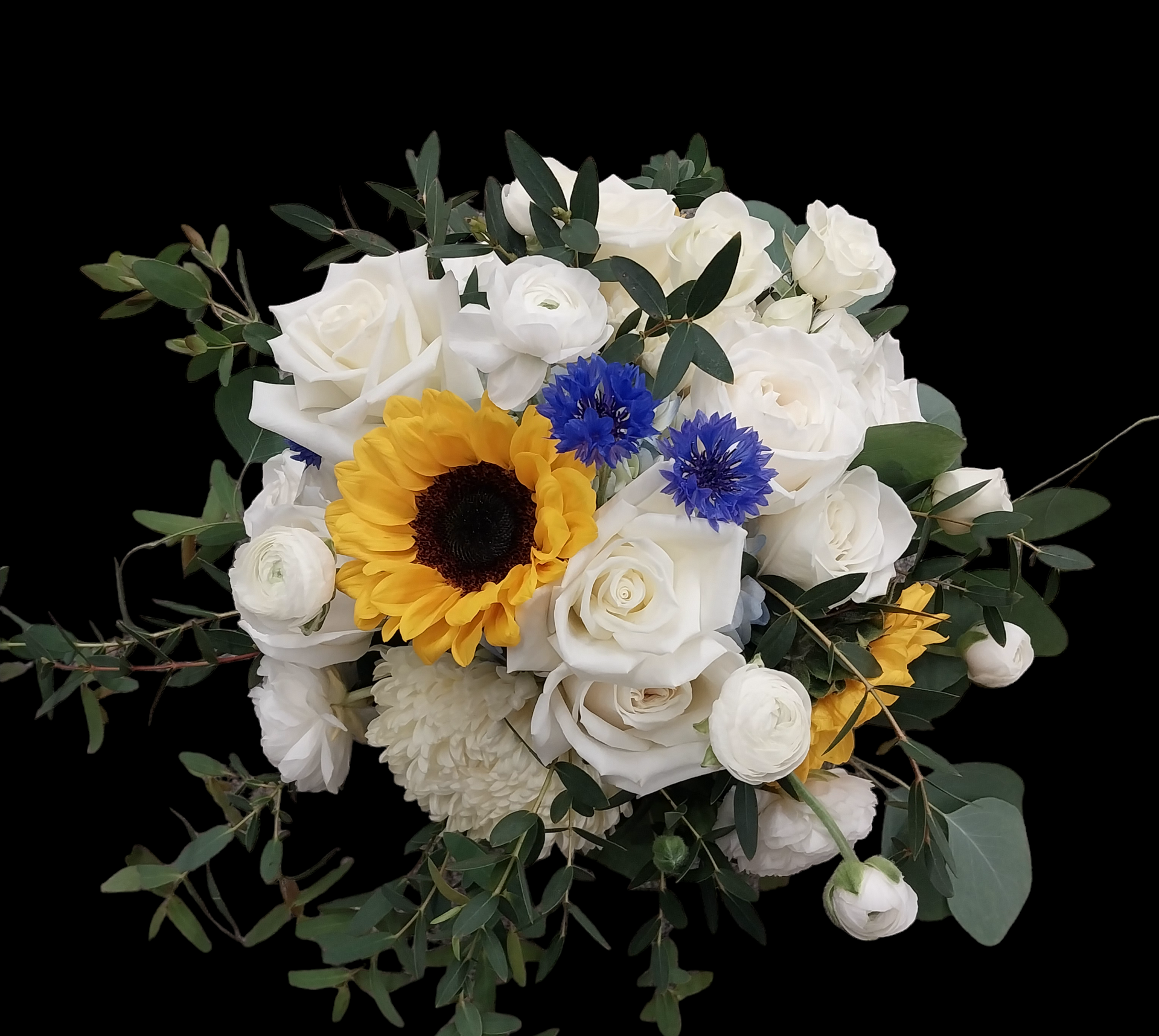 Bouquet of white roses, sunflowers, blue cornflowers, and greenery against a black background.