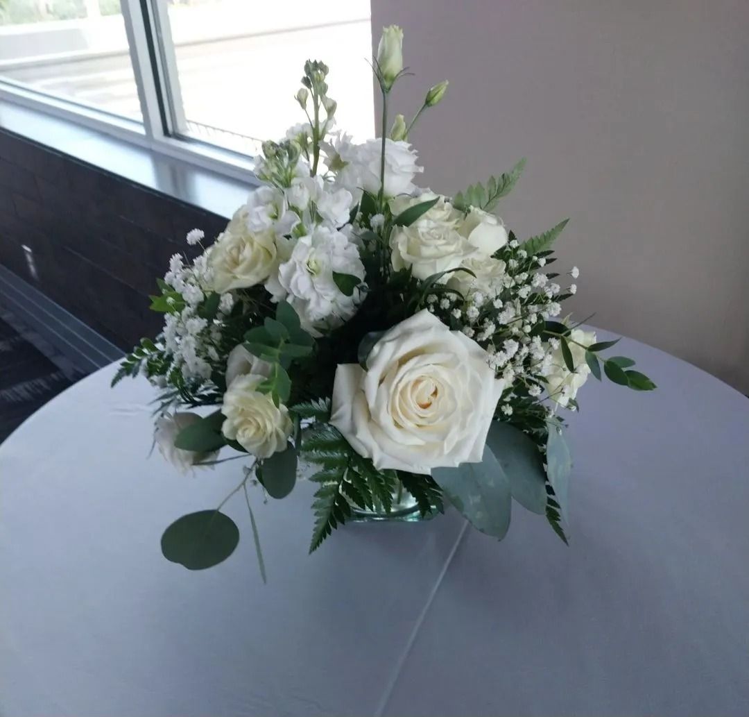 White floral arrangement on a white table.