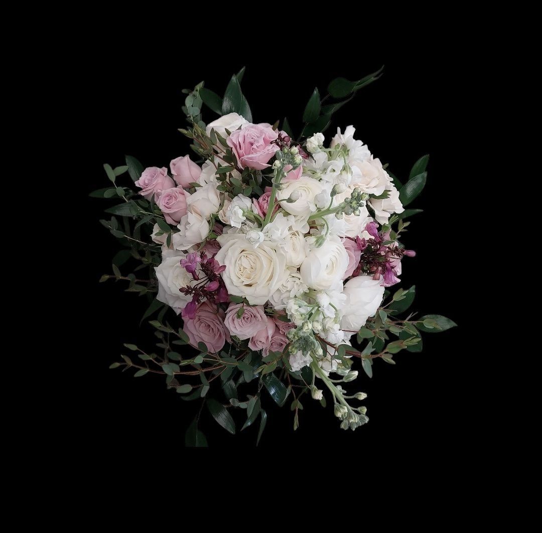 Bouquet of white, pink, and purple flowers with green foliage, centered on a black background.