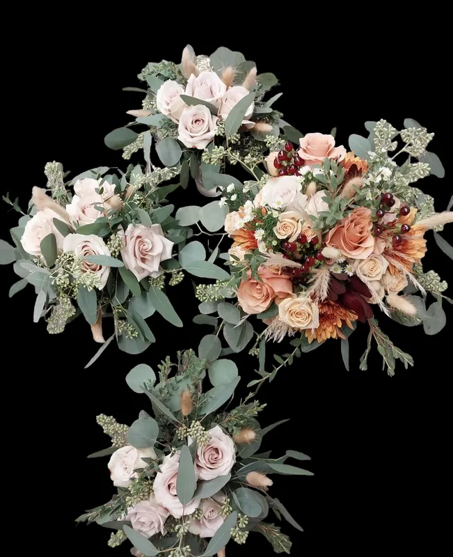 Four wedding bouquets with roses, greenery, and dried flowers against a black background.