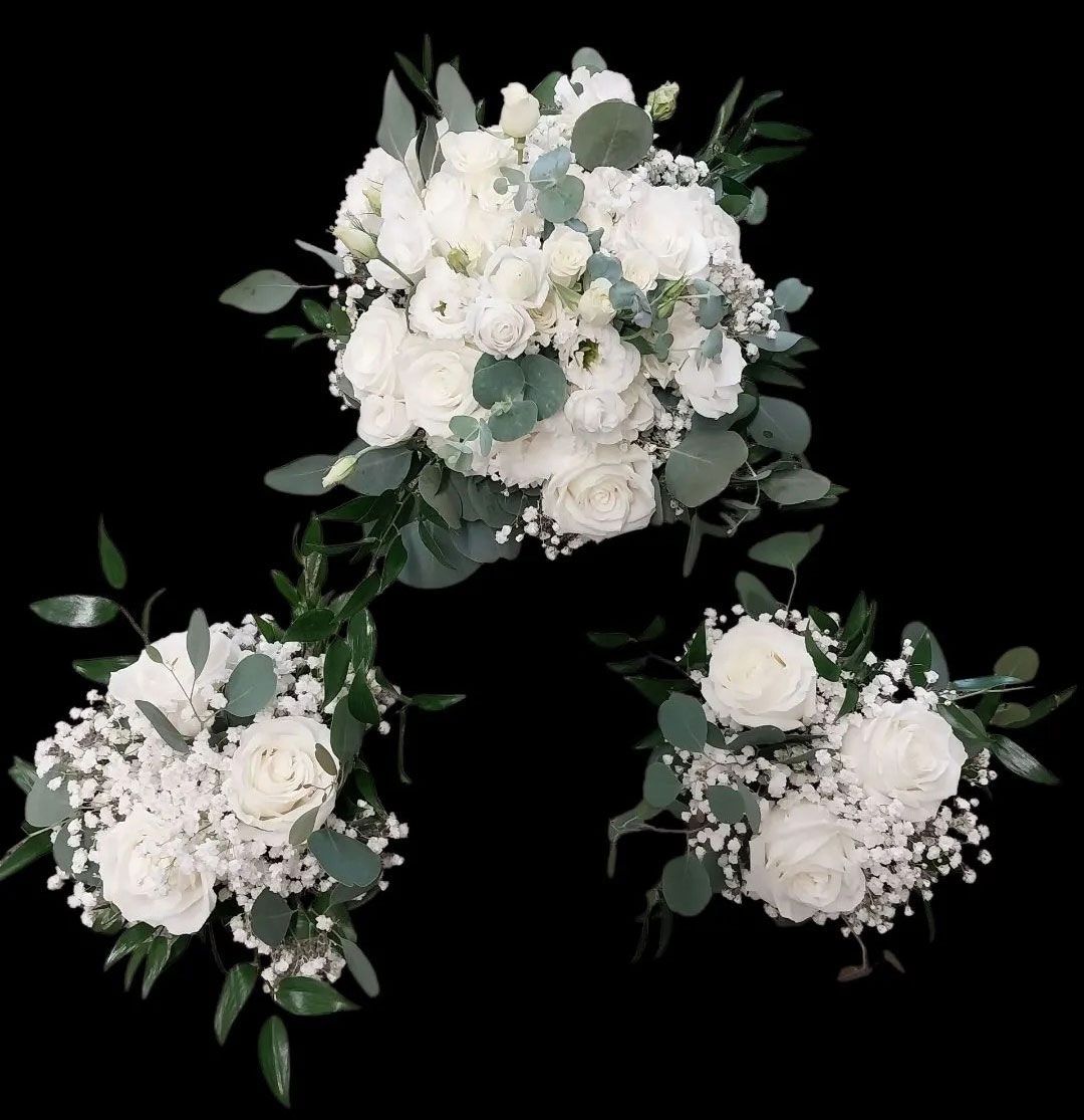 Three white floral bouquets with green foliage against a black background.
