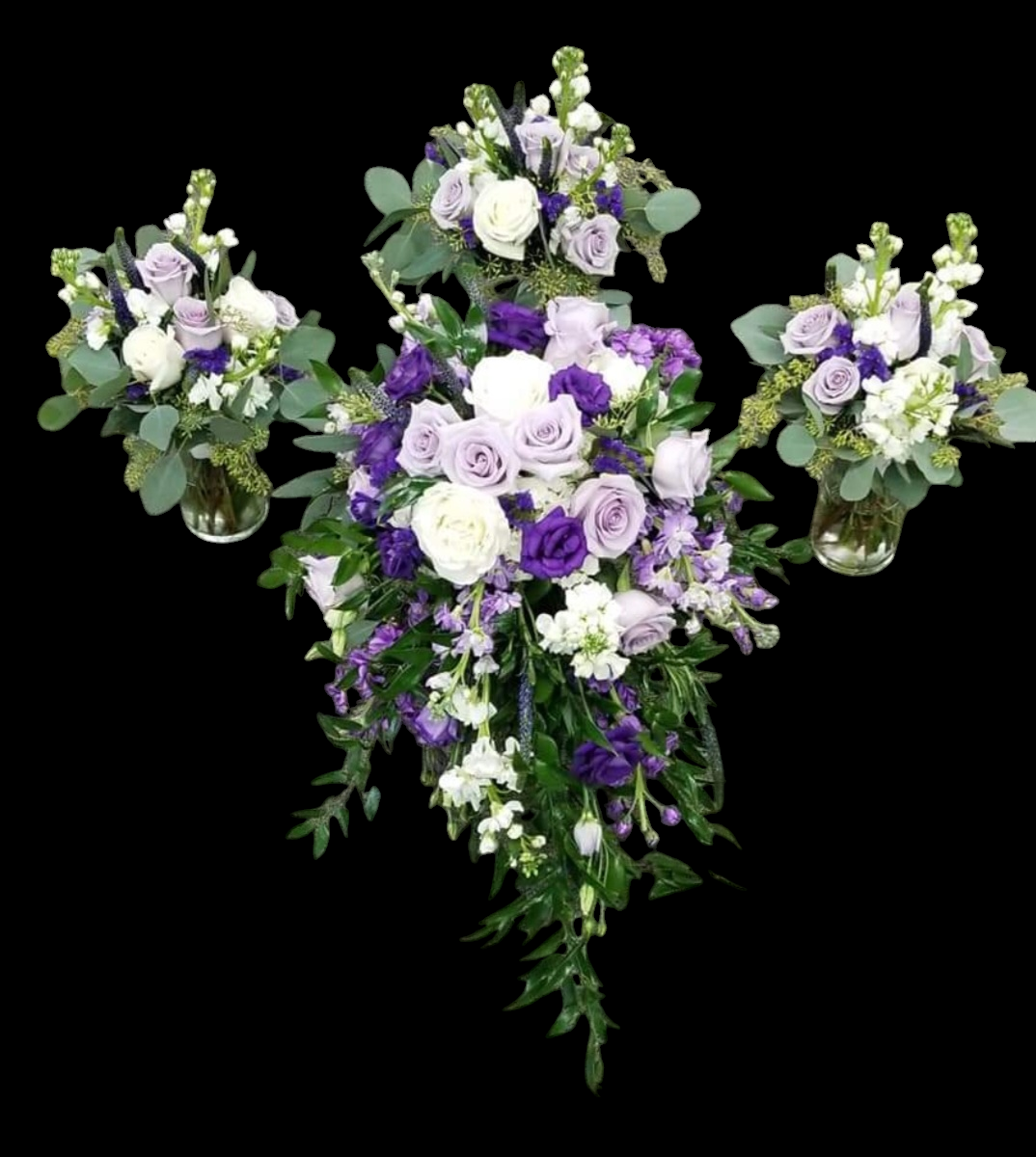 Purple, white, and green flower arrangements with a cascading bouquet and three smaller bouquets.