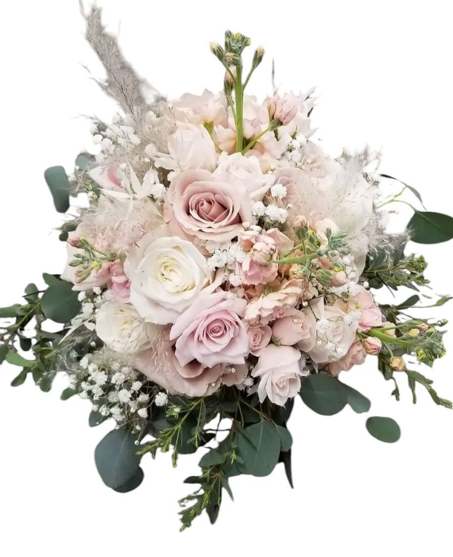 Bouquet of soft pink and white roses, with green foliage.