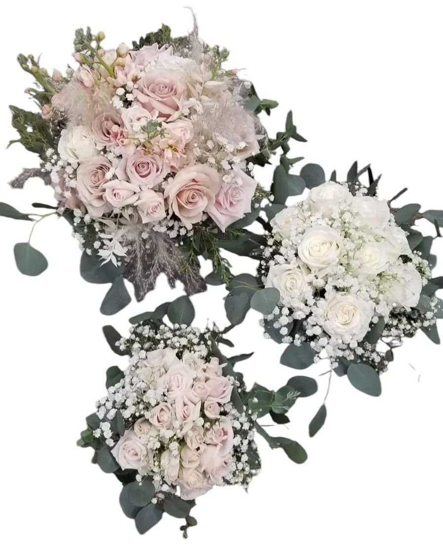 Three bouquets of pink and white roses, with greenery.