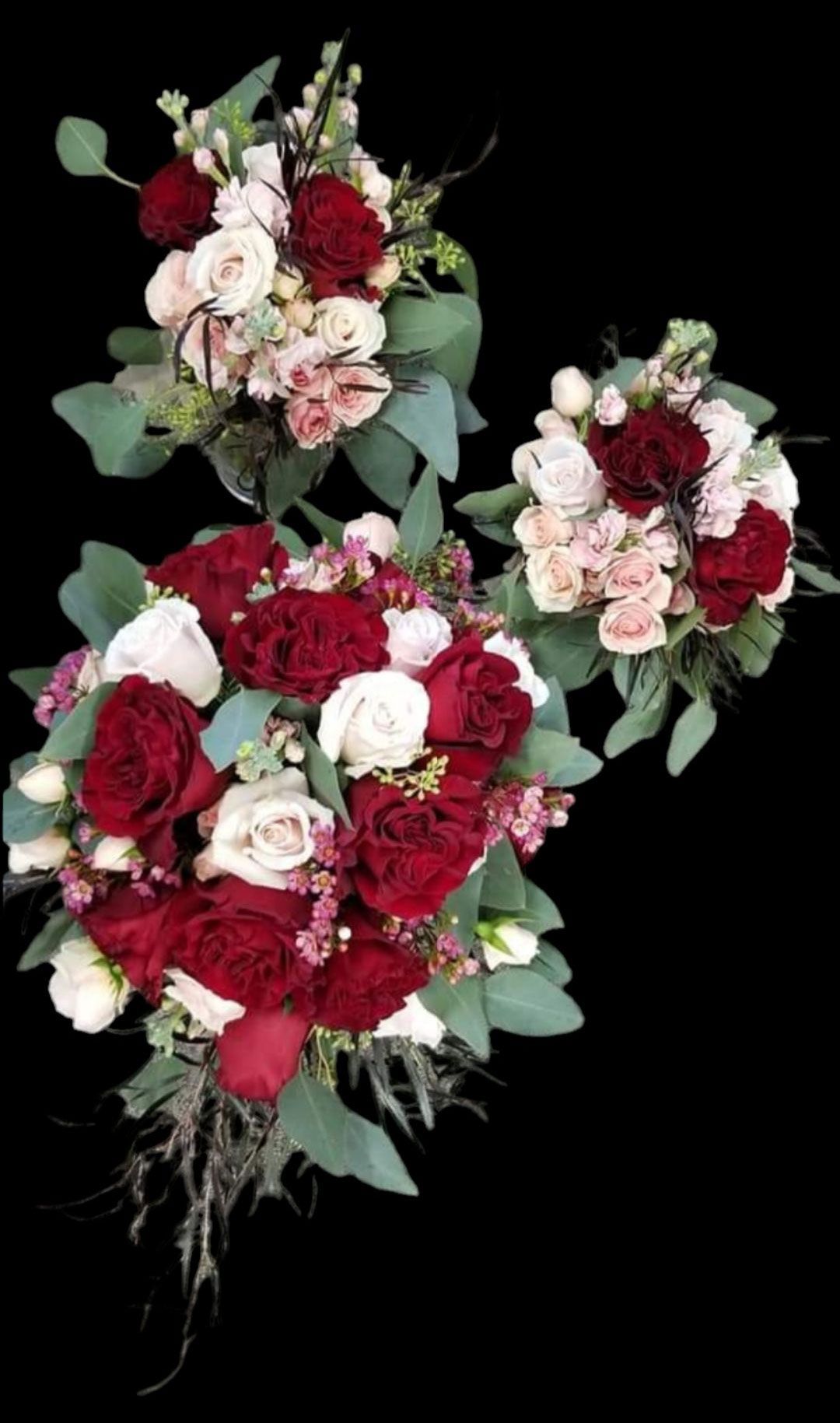 Three bouquets with red, white, and pink flowers and greenery against a black background.