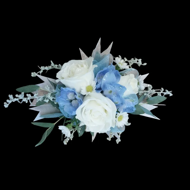 White roses and blue hydrangeas with greenery against a black background.